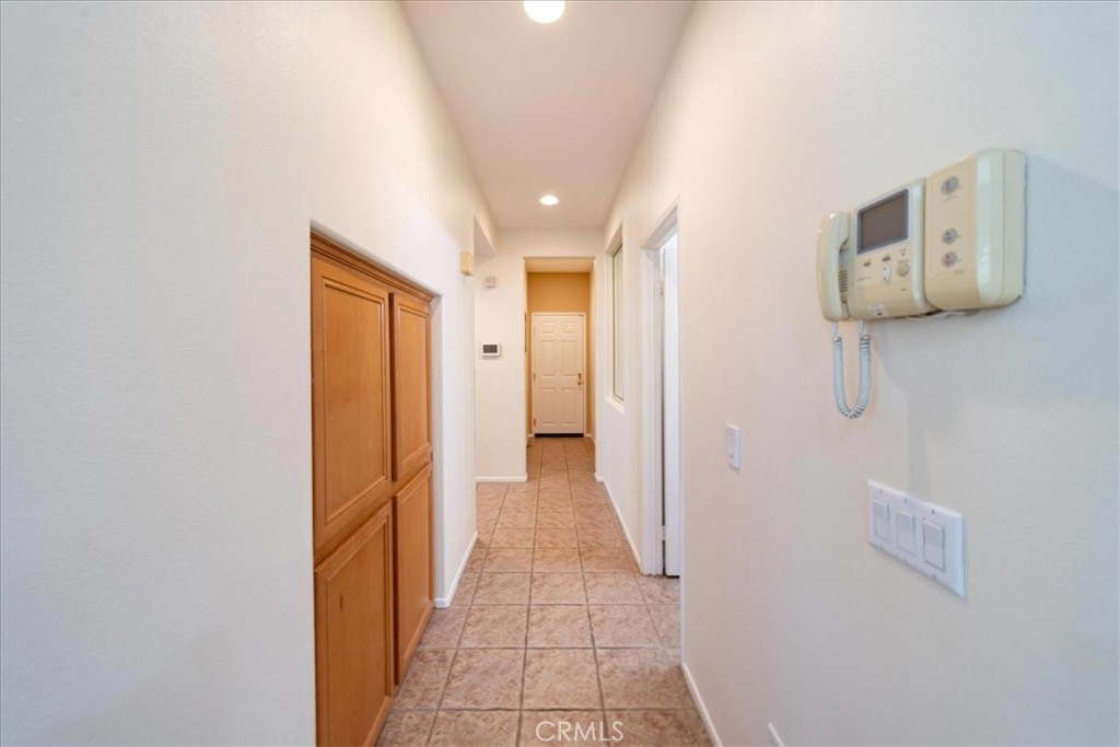 13449 Quail Run Road Eastvale, CA 92880 - Photo 31 of 59 extra cabinet storage in hallway off kitchen