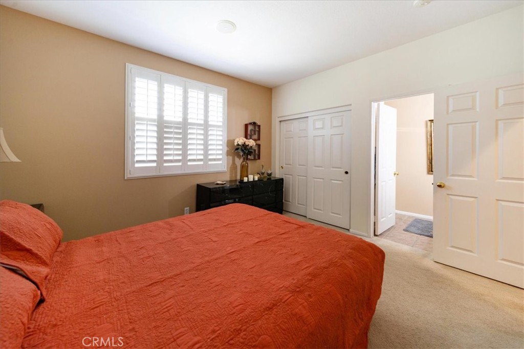 13449 Quail Run Road Eastvale, CA 92880 - Photo 34 of 59 a bedroom with a bed and a window