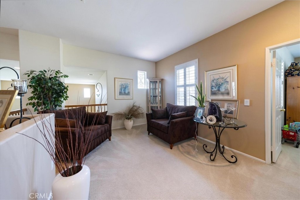 13449 Quail Run Road Eastvale, CA 92880 - Photo 38 of 59 a living room with furniture and a flat screen tv