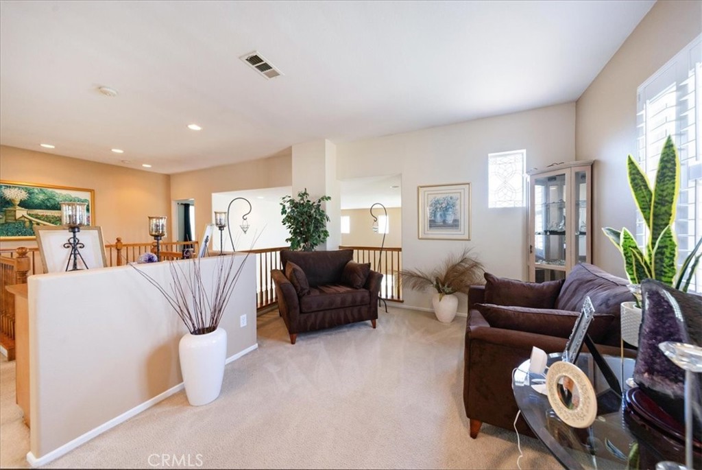 13449 Quail Run Road Eastvale, CA 92880 - Photo 39 of 59 a living room with furniture and a flat screen tv