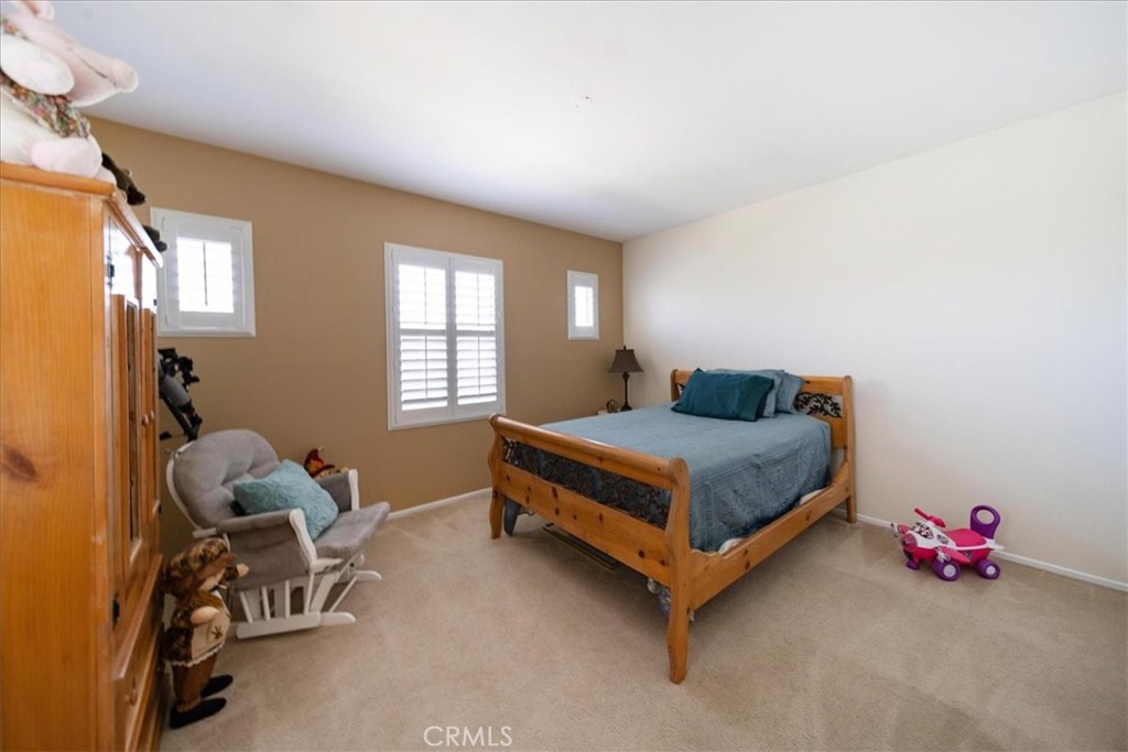 13449 Quail Run Road Eastvale, CA 92880 - Photo 40 of 59 a bedroom with a bed and a window