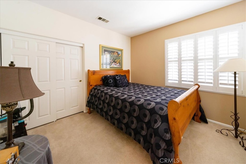 13449 Quail Run Road Eastvale, CA 92880 - Photo 42 of 59 a bedroom with a bed and a table in it