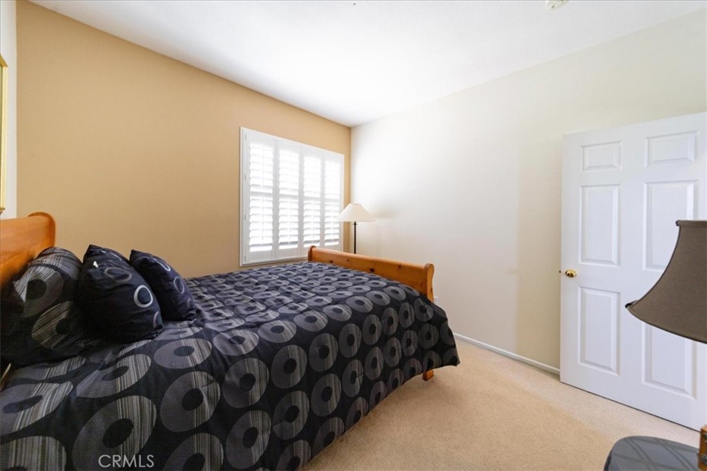 13449 Quail Run Road Eastvale, CA 92880 - Photo 43 of 59 a bedroom with a bed and window