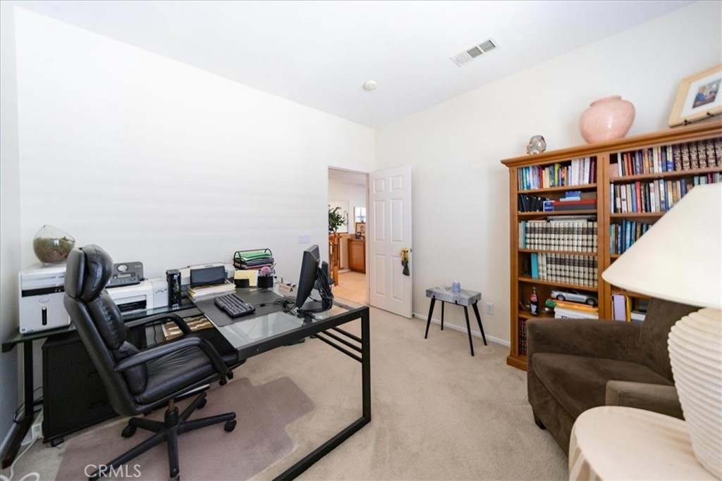 13449 Quail Run Road Eastvale, CA 92880 - Photo 46 of 59 a living room with furniture and a book shelf