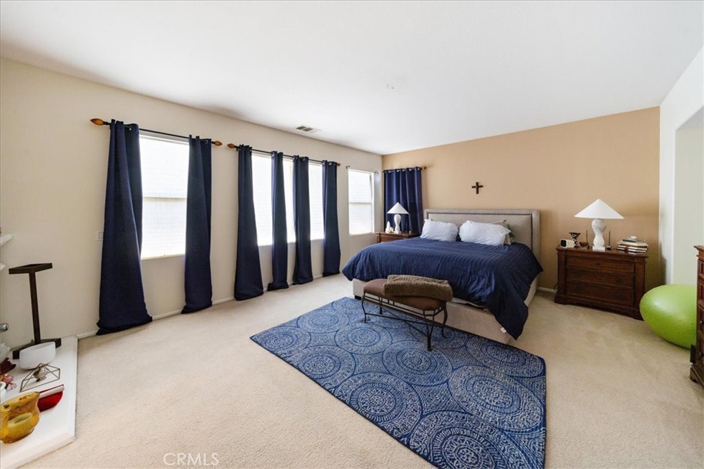 13449 Quail Run Road Eastvale, CA 92880 - Photo 47 of 59 a living room with a bed furniture and a window
