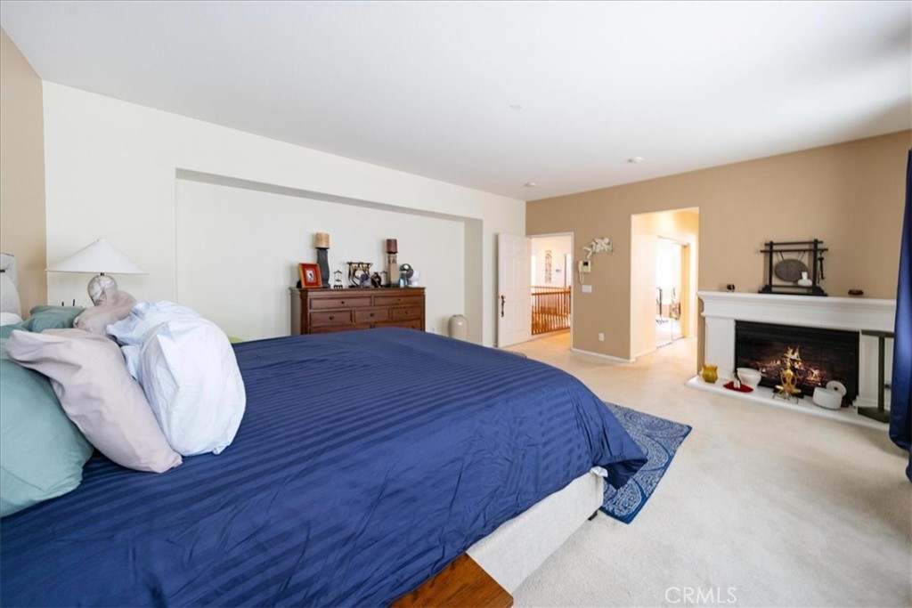 13449 Quail Run Road Eastvale, CA 92880 - Photo 48 of 59 a bed room with a bed and a fireplace