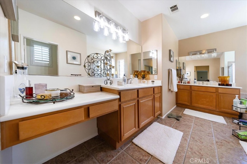 13449 Quail Run Road Eastvale, CA 92880 - Photo 50 of 59 a kitchen with a sink stove and cabinets