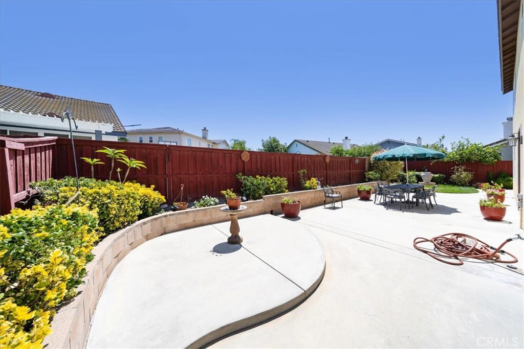 13449 Quail Run Road Eastvale, CA 92880 - Photo 52 of 59 a view of a backyard patio and fire pit