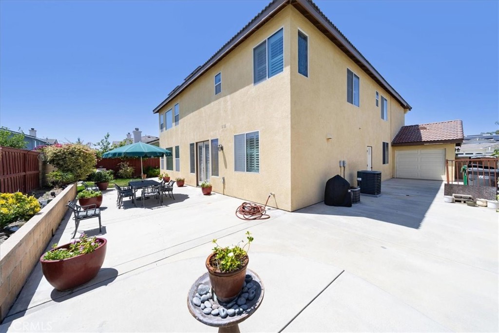 13449 Quail Run Road Eastvale, CA 92880 - Photo 53 of 59 a view of a patio with couches table and chairs and potted plants