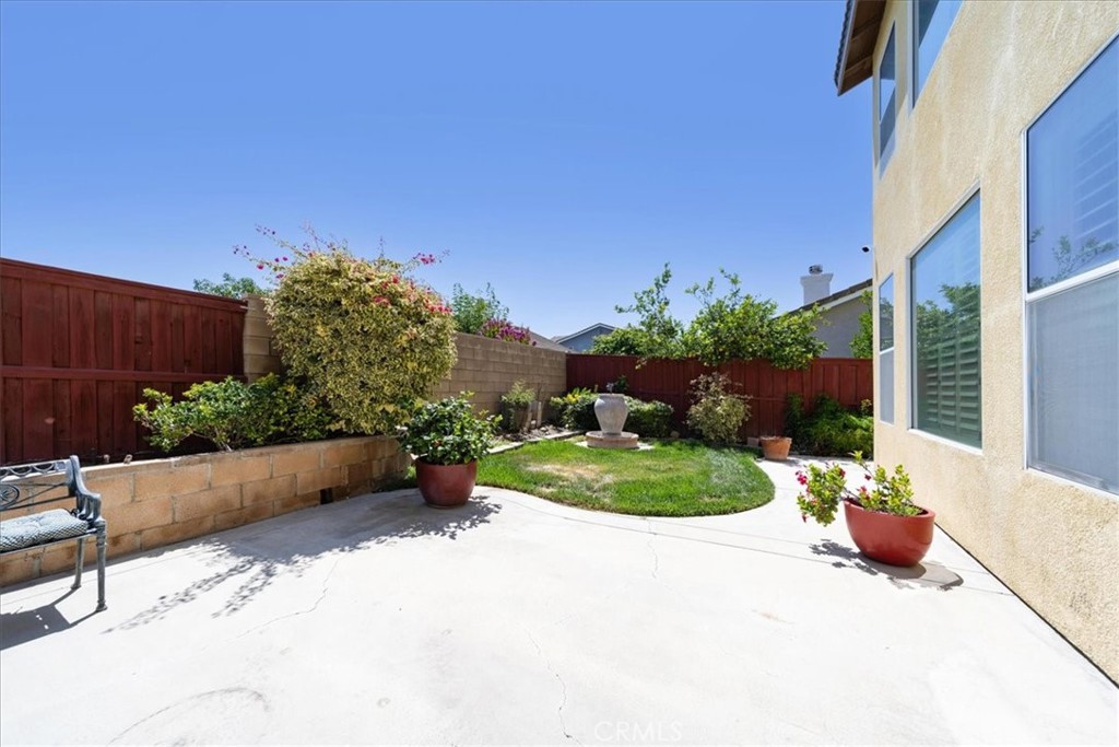 13449 Quail Run Road Eastvale, CA 92880 - Photo 55 of 59 a view of a backyard with plants and a garden
