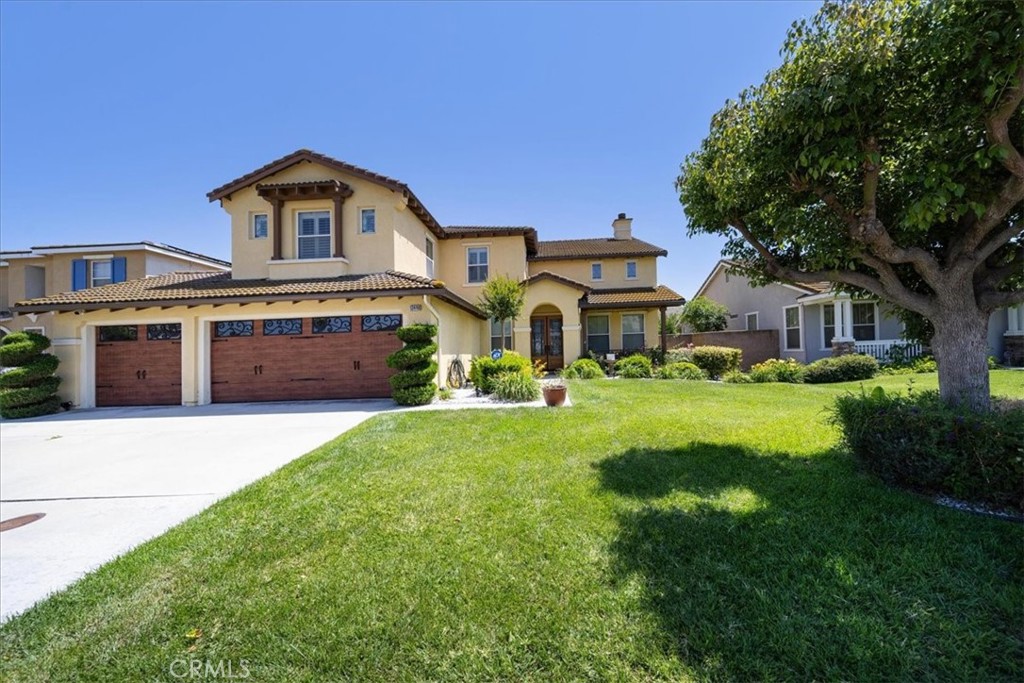 13449 Quail Run Road Eastvale, CA 92880 - Photo 6 of 59 a front view of a house with yard and green space