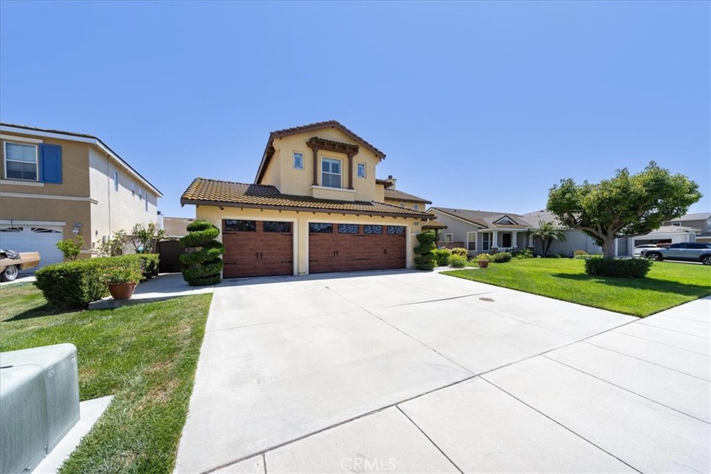 13449 Quail Run Road Eastvale, CA 92880 - Photo 9 of 59 a front view of a house with yard