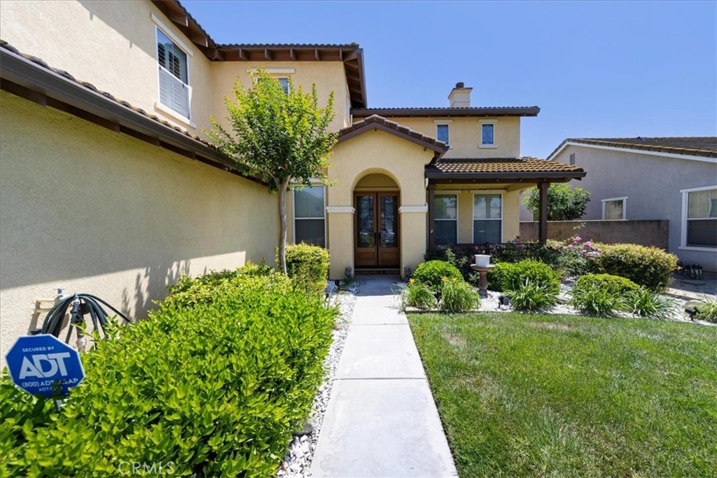 13449 Quail Run Road Eastvale, CA 92880 - Photo 10 of 59 a front view of a house with garden