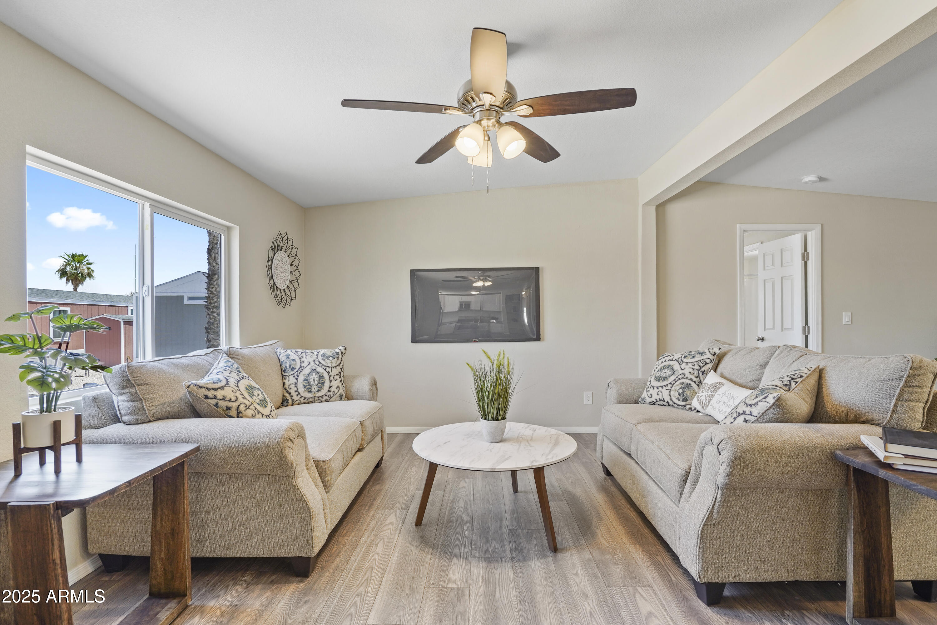 a living room with furniture and a wooden floor