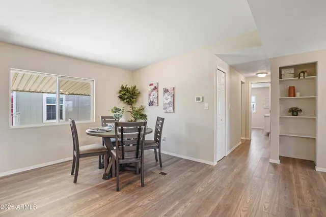 a view of a dining room with furniture and wooden floor