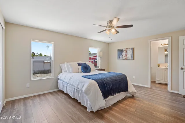 a bedroom with a large bed chandelier and a window