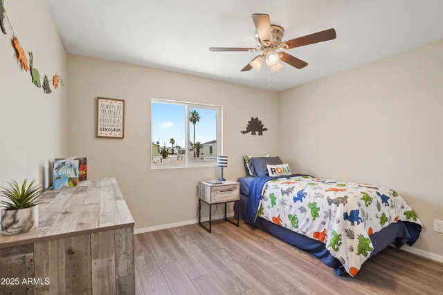 a bedroom with a bed and a chandelier