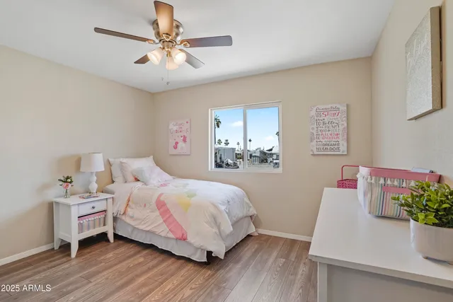 a bedroom with a bed and a potted plant