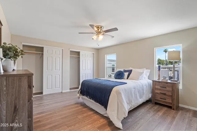 a bedroom with a bed and a potted plant