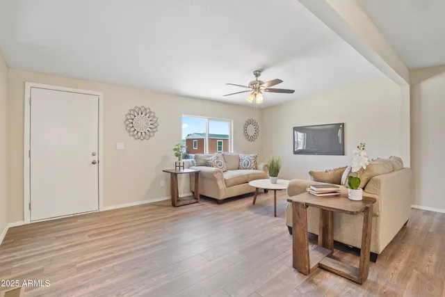 a living room with furniture and a wooden floor