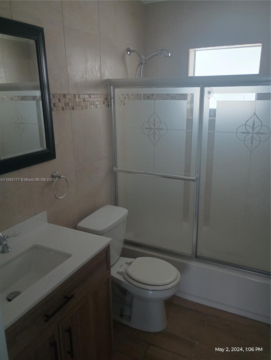 258 Neptune Avenue, Unit N Lauderdale-by-the-Sea, FL 33308 - Photo 11 of 14 a bathroom with a toilet a sink and shower