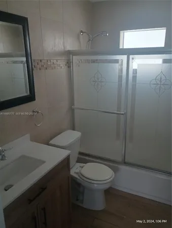 a bathroom with a toilet a sink and shower