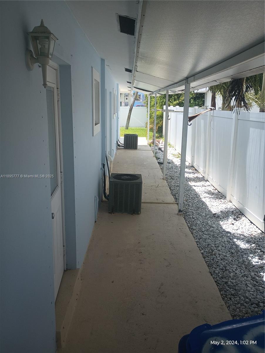 258 Neptune Avenue, Unit N Lauderdale-by-the-Sea, FL 33308 - Photo 6 of 14 a hallway with a couch and a stove