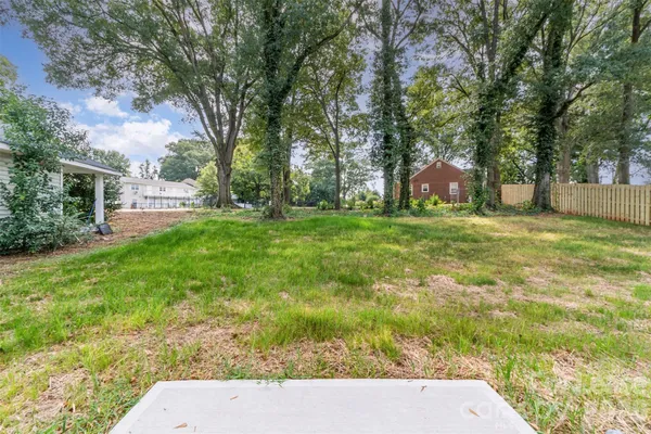 a view of a backyard with large trees