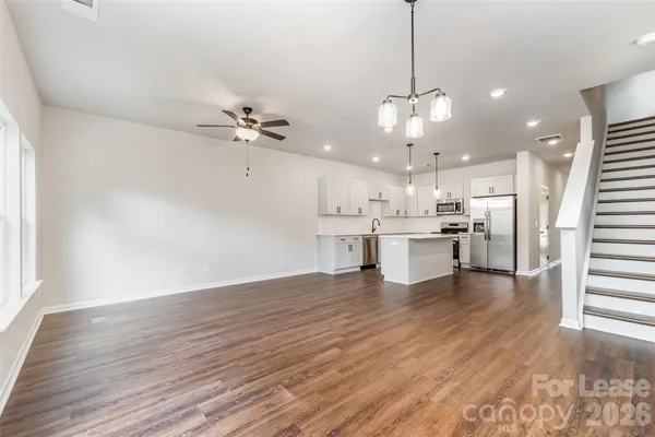 a view of a kitchen with stove and wooden floor