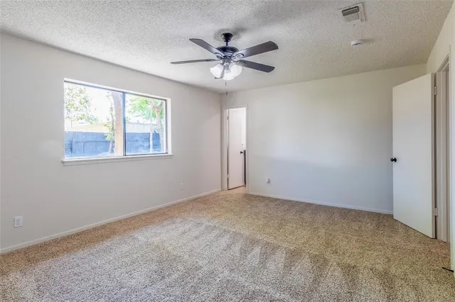 a view of a livingroom with a ceiling fan and window