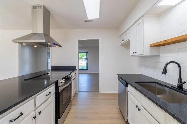 a kitchen with a sink and stove