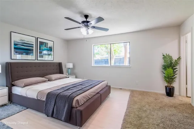 a bedroom with a balcony a bed and a chandelier