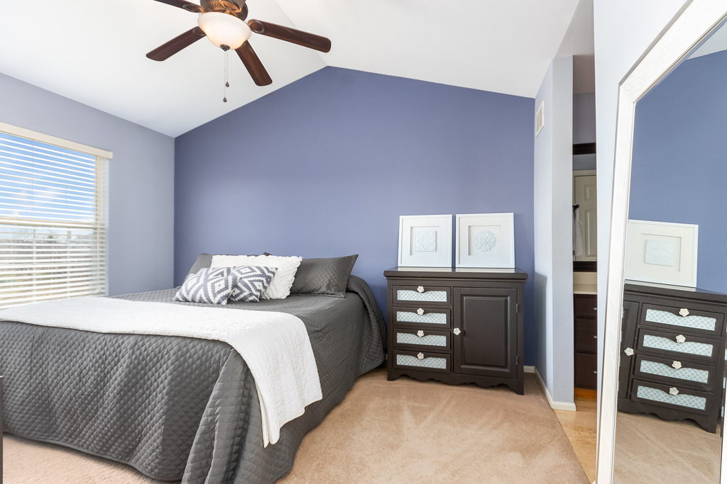 2935 Gypsum Circle Naperville, IL 60564 - Photo 16 of 34 a bedroom with a bed and a chandelier