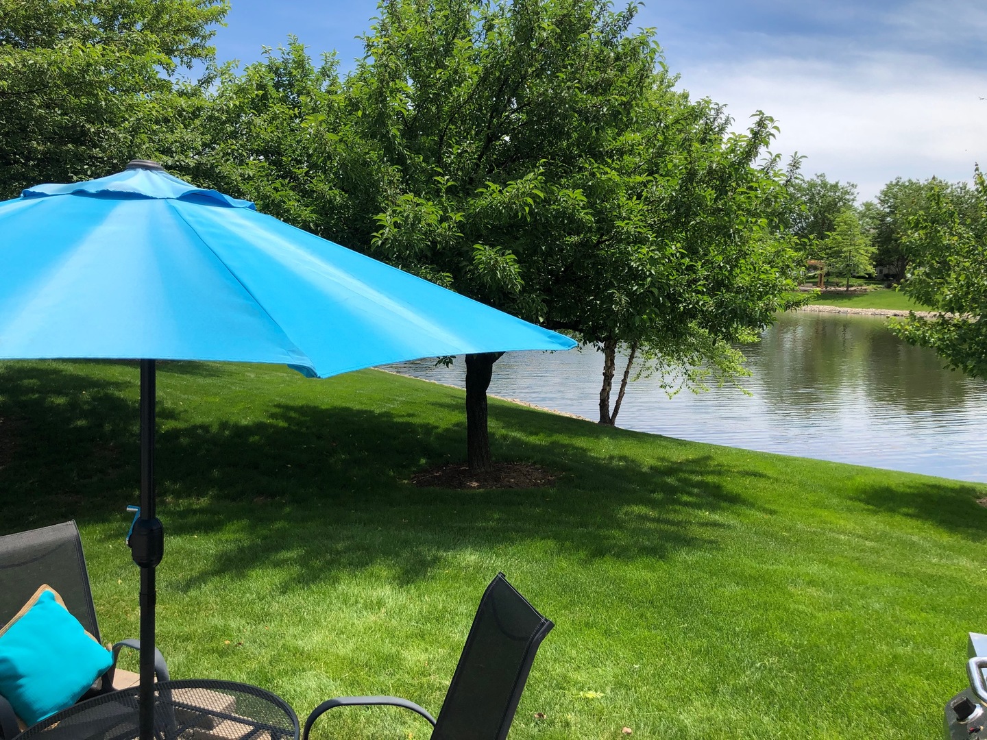 2935 Gypsum Circle Naperville, IL 60564 - Photo 31 of 34 a backyard of a house with table and chairs under an umbrella