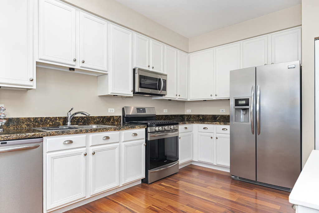 2935 Gypsum Circle Naperville, IL 60564 - Photo 7 of 34 a kitchen with stainless steel appliances granite countertop a stove a refrigerator and a microwave