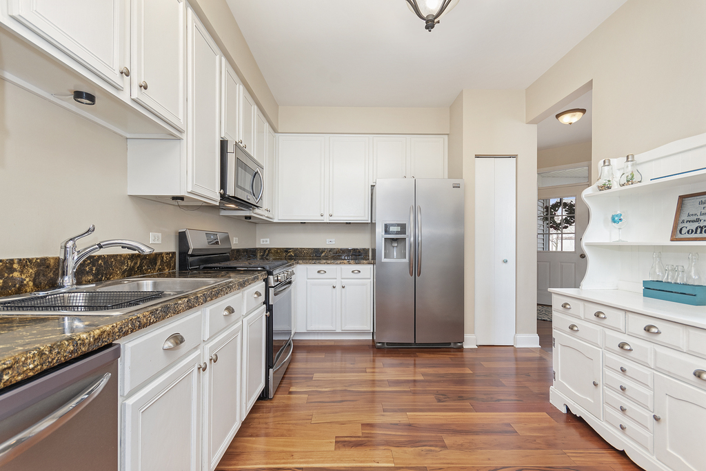 2935 Gypsum Circle Naperville, IL 60564 - Photo 9 of 34 a kitchen with stainless steel appliances granite countertop a refrigerator and a sink