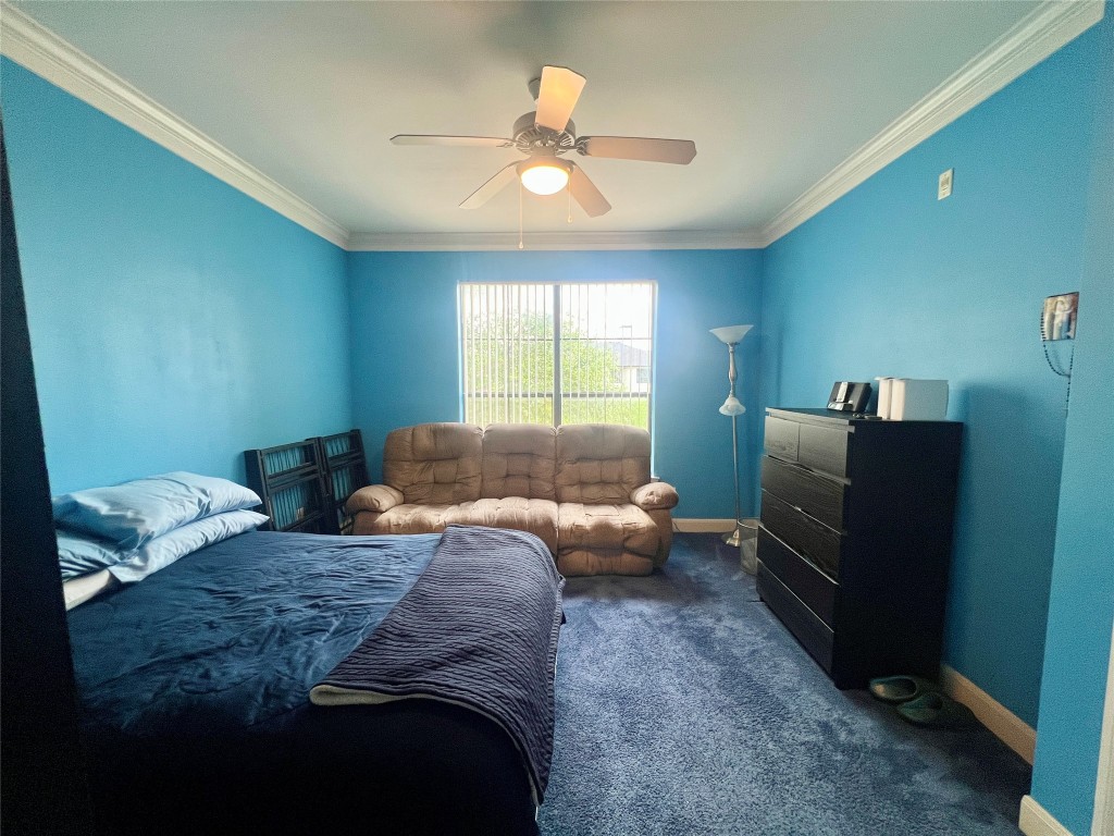 7701 Rialto Boulevard, Unit 1328 Austin, TX 78735 - Photo 15 of 17 Bedroom with ornamental molding, dark colored carpet, and ceiling fan