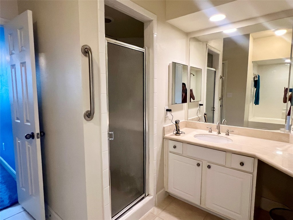 7701 Rialto Boulevard, Unit 1328 Austin, TX 78735 - Photo 3 of 17 Bathroom with vanity, a shower stall, and light tile patterned flooring