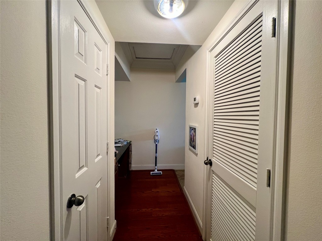 7701 Rialto Boulevard, Unit 1328 Austin, TX 78735 - Photo 5 of 17 Hallway with dark wood-style flooring and attic access