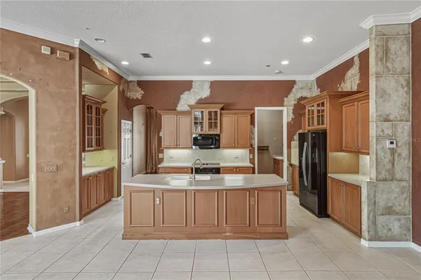 a kitchen with stainless steel appliances granite countertop a sink and a refrigerator