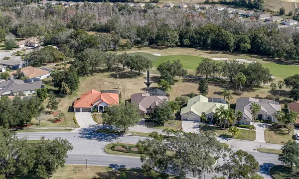 an aerial view of house with yard swimming pool and outdoor seating