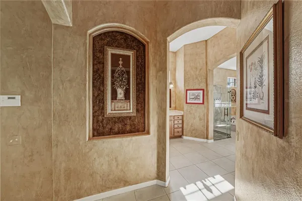 a room with furniture pool table and glass windows