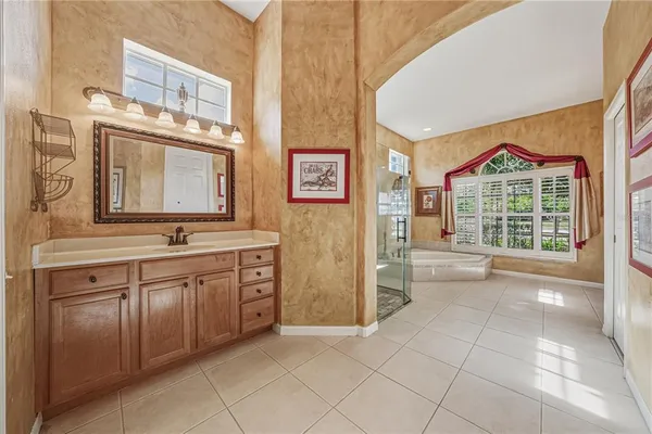 a living room with patio furniture and a garden