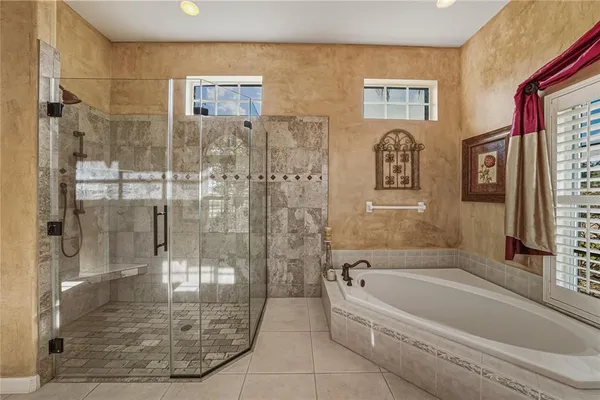 a view of a backyard patio with table and chairs under an umbrella