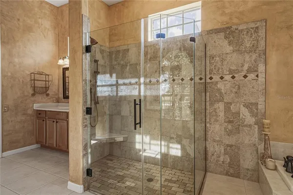 a view of a house with a yard and potted plants