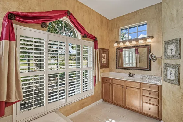 a view of a building with a bench and potted plants