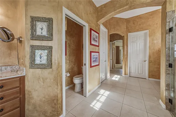 a view of a balcony with chairs and iron fence