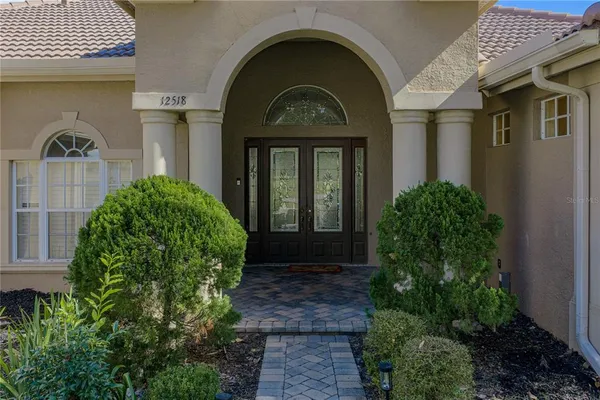 a view of a room with wooden floor and chandelier