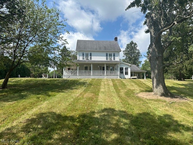 976 East Calla Road Youngstown, OH 44514 - Photo 1 of 10 Back of property featuring a porch, a yard, and a chimney