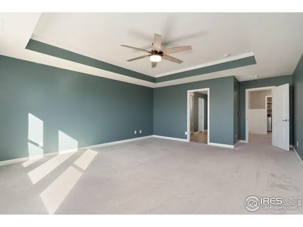 a view of an empty room with a ceiling fan